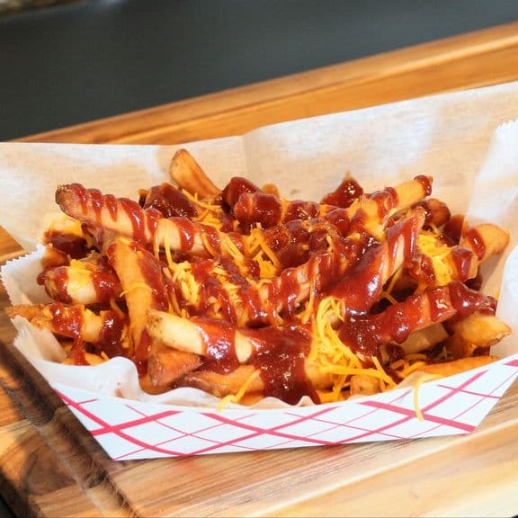 BBQ Fries - Crispy french fries topped with your choice of BBQ dressing and shredded cheddar cheese. A smoky-sweet combination.