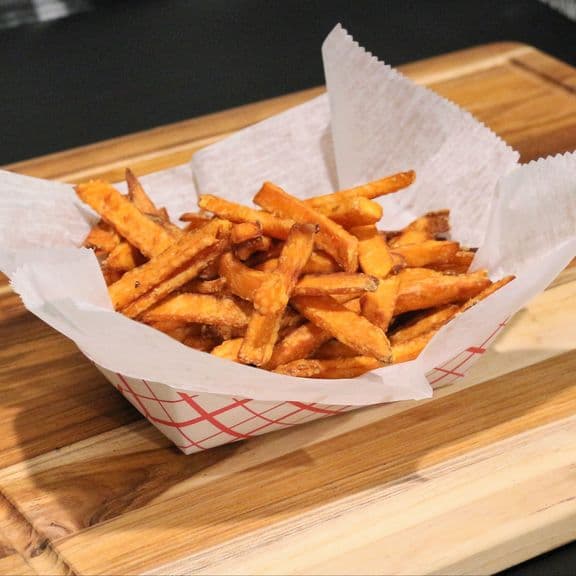 Sweet Potato Fries - Premium cut sweet potato fries, offering a perfect balance of sweet and savory with a crispy exterior and tender interior.
