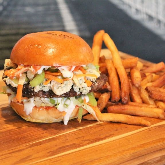 Buffalo Trip (Hot) Burger - Fresh and natural, hand crafted ground beef patty, lettuce, crumbled blue cheese, celery, carrot and hot sauce.
