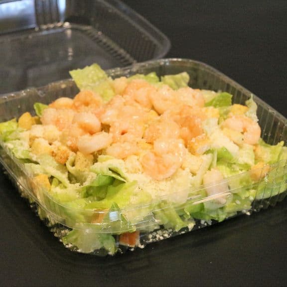 Shrimp Caesar Salad - Tender baby shrimp served over fresh lettuce with crunchy croutons and shaved Parmesan cheese. Accompanied by our creamy Caesar dressing.